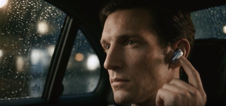 Man in a car at night using Liberty 5 Pro Max earbuds for clear voice control and AI translation