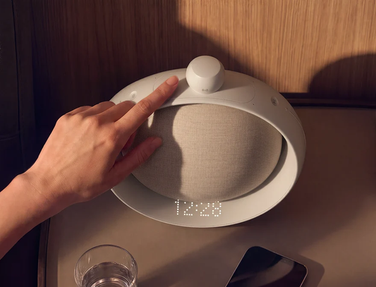 Anker soundcore SleepLab Pro sleep sound machine being adjusted at bedtime