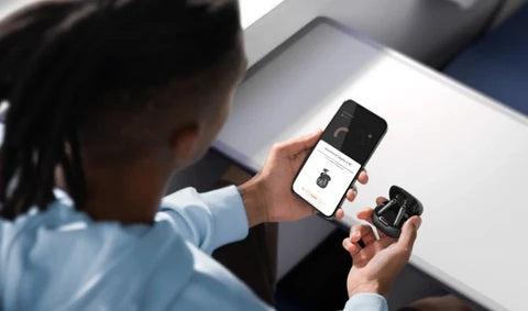 Person connecting wireless earbuds to an iPhone.