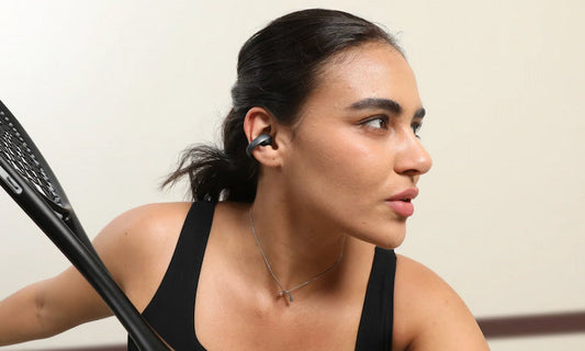 Woman wearing soundcore open-ear headphone
