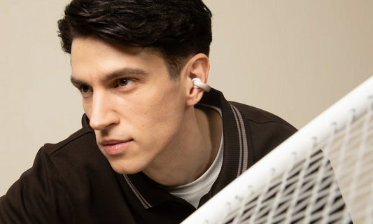 Man wearing soundcore earbuds while working out