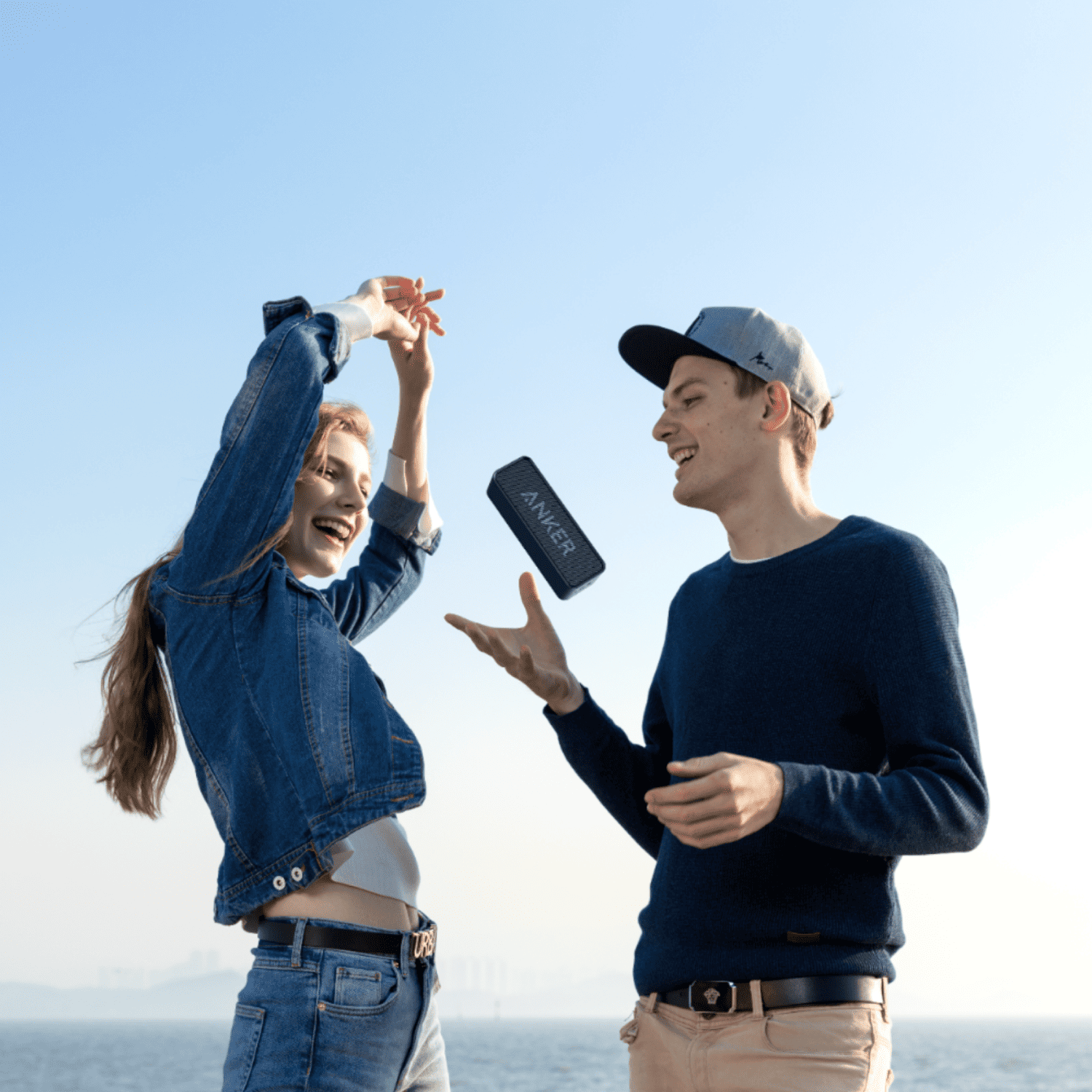 Young people outdoors with ANKER speaker for fun