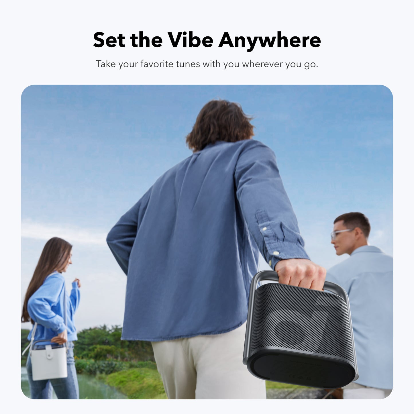 Man carrying soundcore speaker with integrated handle outdoors