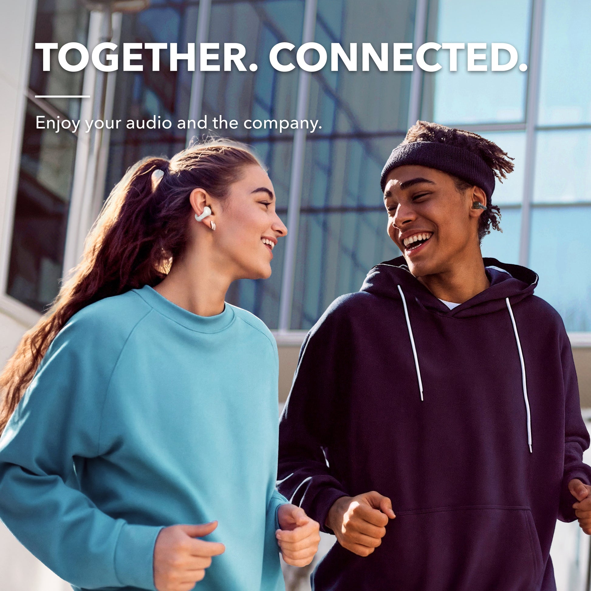 Two people running with soundcore earbuds
