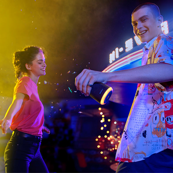 man holding soundcore speaker with glowing LED ring