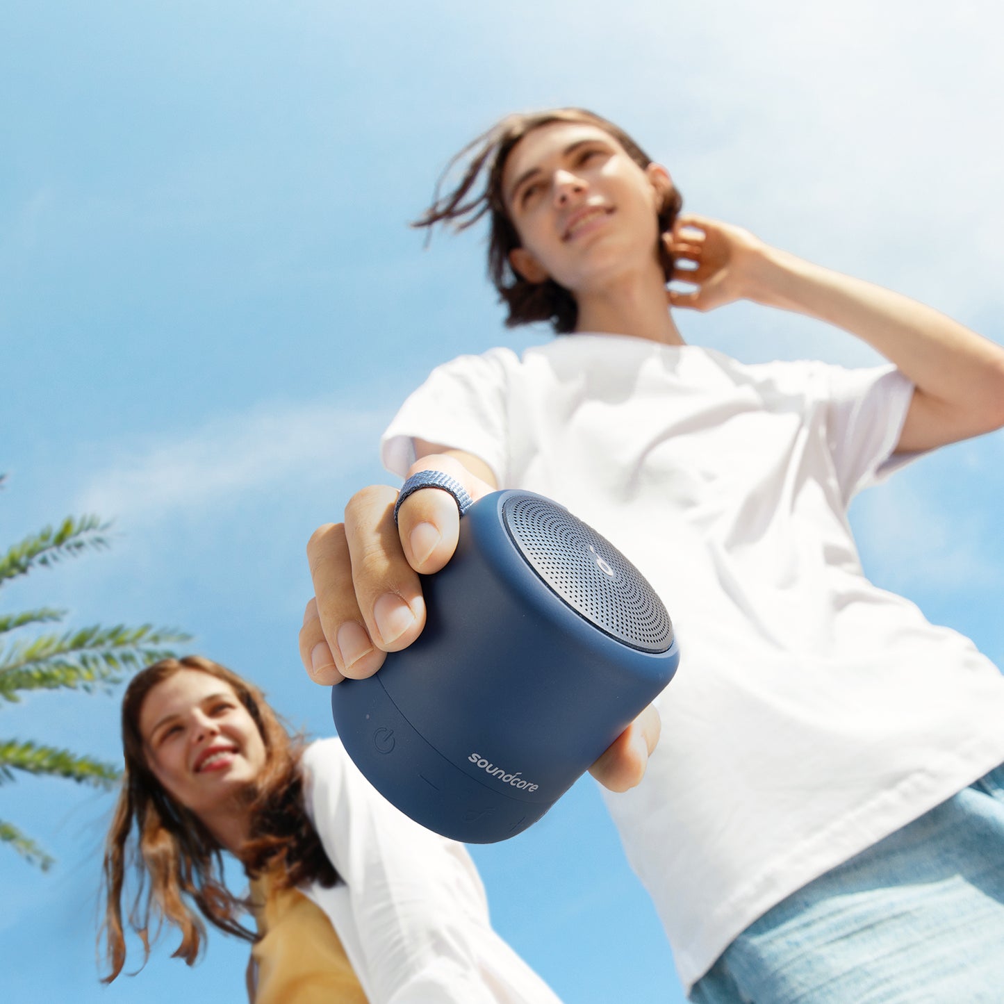person holding soundcore portable speaker with outdoor background